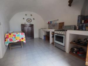 a kitchen with a stove and a table in it at Casa del Limone in Filicudi