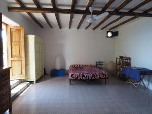 a bedroom with a bed and a wooden ceiling at Casa del Limone in Filicudi