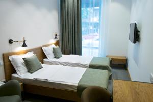 Letto o letti in una camera di R&R Hotel