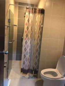 a bathroom with a shower curtain and a toilet at One Madison Place, Tower 2 - 10N MEGAWORLD Iloilo in Iloilo City
