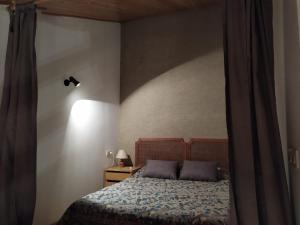 a bedroom with a bed with two pillows on it at Apartament Donadó - Port del Comte in La Coma i la Pedra