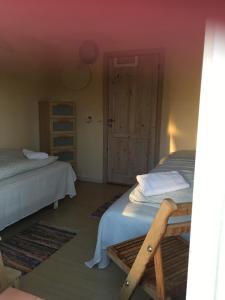 a bedroom with two twin beds and a door at Margretelyst in Farsø