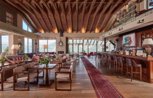 a restaurant with tables and chairs and a bar at Orizontes Tzoumerkon Hotel Resort in Pramanta