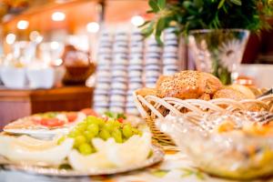 a table topped with plates of bread and pastries at Hotel Sonnenhof in Bad Sachsa