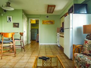 a kitchen and a living room with a refrigerator at Ragged Edge Resort & Marina in Islamorada