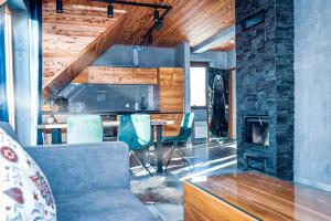 a living room with a couch and a fireplace at Bury Miś in Jaworki