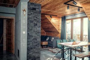 a living room with a table and a couch at Bury Miś in Jaworki +19 photos