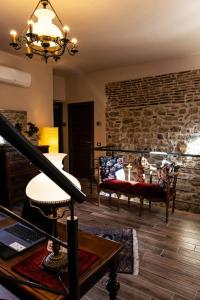 a living room with a staircase and a stone wall at Il Carro Comfortable Rooms in San Giovanni Gemini