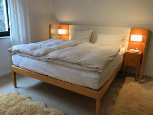 a bed with white sheets and pillows on it at 2 Room Messe Kongress Stadion in Dortmund