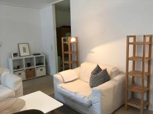 a living room with a white couch and a table at 2 Room Messe Kongress Stadion in Dortmund