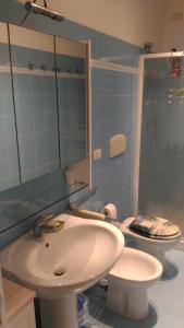 a bathroom with a sink and a toilet and a mirror at aMare il mare in Porto Recanati +25 photos