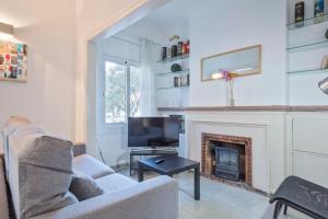 a living room with a couch and a fireplace at Apartamentos Tarradellas Sants Estació in Barcelona