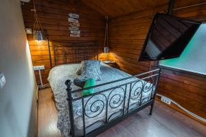 a bedroom with a bed and a flat screen tv at Fuente del Lobo Glamping & Bungalows - Adults Only in Pinos Genil