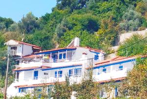a large white building on top of a hill at Alexandra's Studios in Kechria
