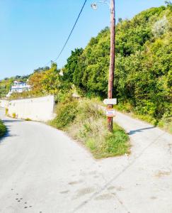 a telephone pole on the side of a road at Alexandra's Studios in Kechria
