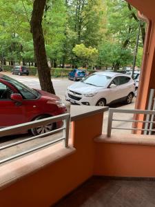 un balcón con un coche rojo estacionado en una calle en Casa Bea, en Cremona