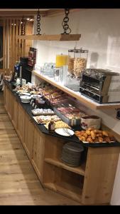 a buffet line with many different types of food at Garní Nëidia in Selva di Val Gardena