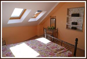 a bedroom with a bed in a room with skylights at Apartamento en zona rustica de Camariñas in Camariñas