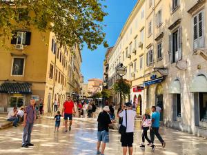 a group of people walking down a city street at Apartment Karin in Rijeka
