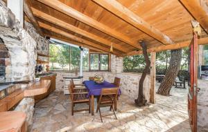 an outdoor dining room with a table and chairs at Ranch Frida in Vodice