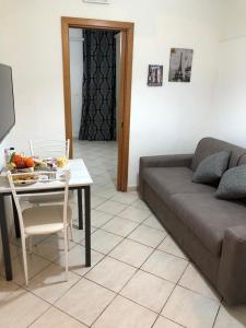 ein Wohnzimmer mit einem Sofa und einem Tisch in der Unterkunft La casetta 75 in Neapel