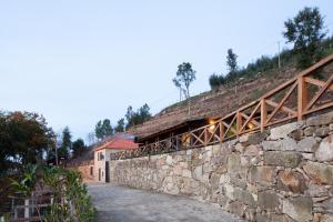 a stone wall with a bridge on top of it at Casa do Avô in Cinfães
