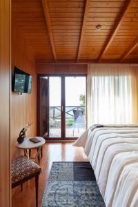 a bedroom with a bed and a tv on a wall at Casa do Avô in Cinfães