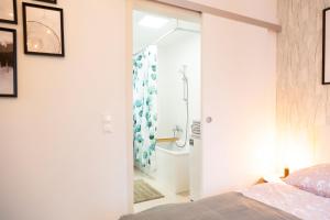 a bedroom with a glass door leading to a shower at Green & cozy apartment - 15 min to city center in Vienna