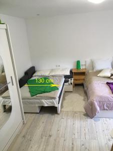 a room with two beds and a table with a desk at Aparthotel Pr' Jakapč' in Mojstrana