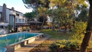 a backyard with a swimming pool and a house at Can Ramón in Caldes de Montbui