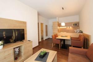 a living room with a television and a dining room at Ferienresidenz Grafenmatt, Feldberg in Feldberg