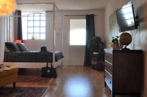 a living room with a bed and a television at Villa Sandby B&B in Borrby
