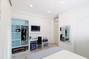 a bedroom with a bed and a tv and a mirror at Dreams Tropea Mare "Parking Private" in Tropea