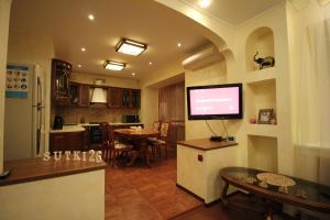 a kitchen and living room with a television and a table at 2-комн VIP квартира в самом сердце Пятигорска by Sutki26 in Pyatigorsk