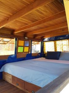 a bed in the back of a van with windows at CALA Guane Barichara in Guarne