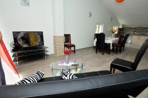 a living room with a couch and a table at Apartment Fiorenini 2 in Mlini