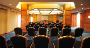 a room with rows of chairs in a conference room at Marina Plaza Hotel Tala Bay in Aqaba