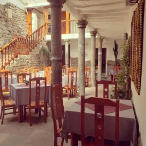 a restaurant with tables and chairs on a patio at Hotel Sueños del Inka in Cusco