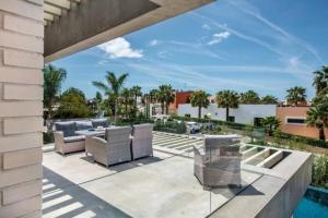 an outdoor patio with furniture and a swimming pool at VILLA BEAU in Ferragudo