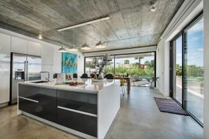 a large kitchen with a counter and a dining room at VILLA BEAU in Ferragudo