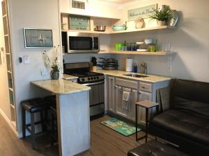 a small kitchen with a stove and a counter at Spectacular Beach View! in Corpus Christi