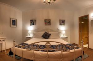 カザル・ダ・ラゴア・セッカにあるPraia D'El Rey - Caravelasのベッドルーム1室(大型ベッド1台、テーブル2台付)