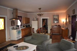 a living room with two couches and a kitchen at Inn at the L C Ranch in Gila