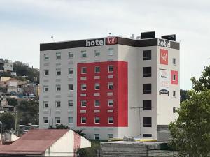 hotel z czerwonym paskiem na boku budynku w obiekcie Hotel Hi! Queretaro w mieście Querétaro