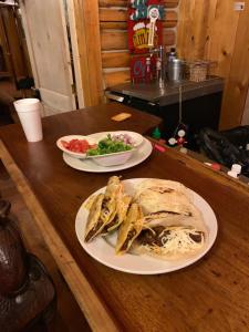 two plates of food on a wooden table at Heart Six Ranch in Moran