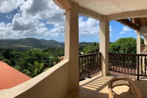 a balcony of a house with a view of the mountains at Villa Xona in Castries