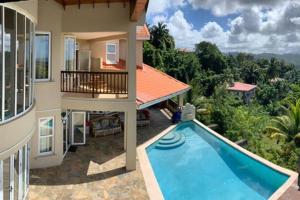 an aerial view of a house with a swimming pool at Villa Xona in Castries