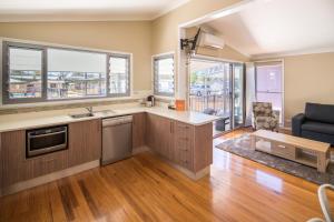 an open kitchen with a couch and a table at Ingenia Holidays Hunter Valley in Cessnock