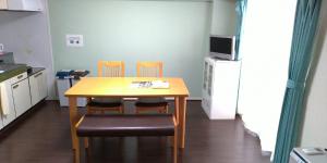 a small kitchen with a table and two chairs at 札幌市中心部大通公園まで徒歩十分観光移動に便利なロケーションh703 in Sapporo