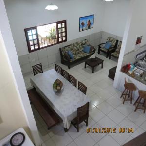 a living room with a couch and a table and chairs at Casa Tamandaré in Tamandaré